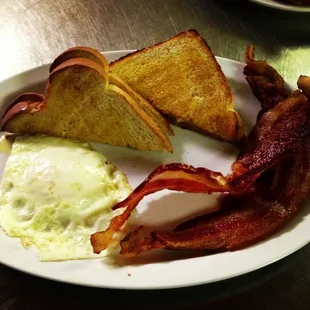 bacon, toast, and eggs on a plate