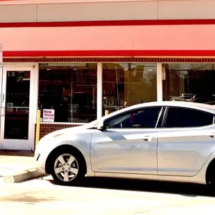 a car parked in front of a restaurant