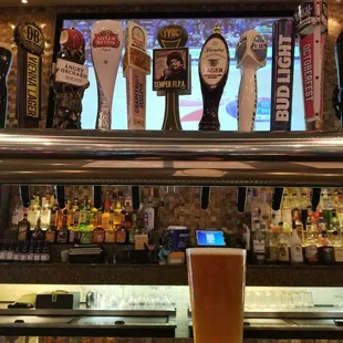 a pint of beer on a bar