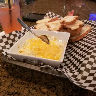 a bowl of gravy and bread