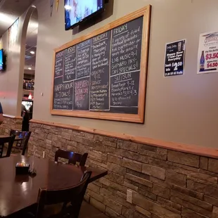a restaurant with a menu on the wall
