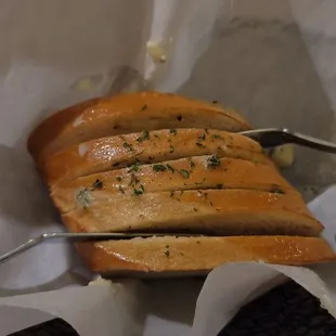 a knife and fork in a basket of bread