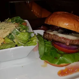 House Bacon cheese Burger with side Caesar salad.