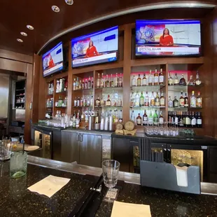 a bar with several televisions on the wall