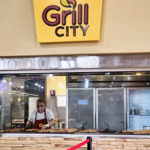 a man standing in front of a grill