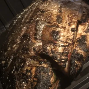 Grilled Pompano charred on the outside overcooked on the inside.