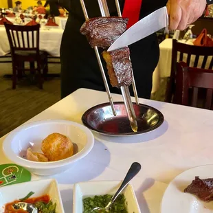 a man cutting a steak