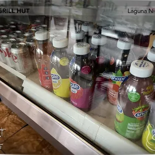 a variety of drinks in a display case