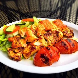 Chicken and Fish kabob with salad and grilled tomatoes