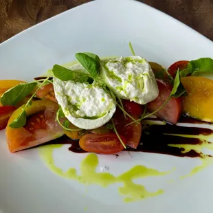 Heirloom Tomato &amp; Burrata--

Assorted heirloom tomatoes, olive oil &amp; basil emulsion, Maldon sea salt, aged balsamic vinegar