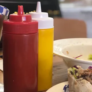 Tzatziki in yellow and spicy hot pepper sauce in red