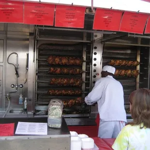 a man and a woman cooking chicken