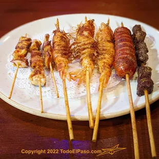 a plate of skewered food