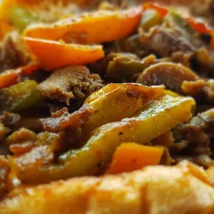 a closeup of a sandwich with meat and peppers