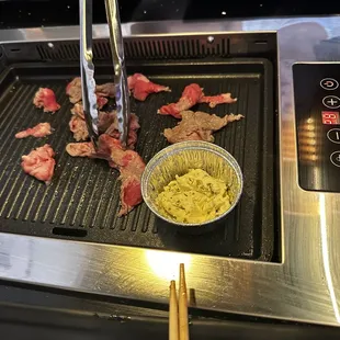 a bowl of food and chopsticks