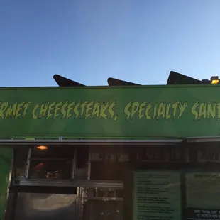 a green sign for a restaurant