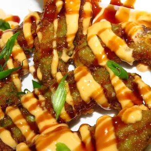 Panko Crusted Avocado- golden brown, crispy slices of fresh avocado, dressed with spicy mayo and eel sauce