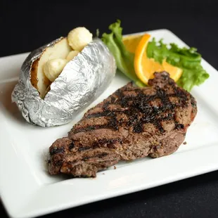 a steak and a baked potato on a plate