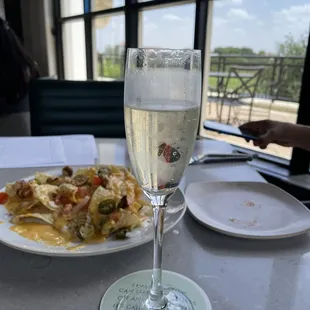 a plate of food and a glass of wine