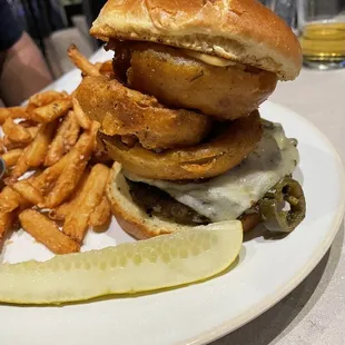 blackened Cajun burget with onion rings, wonderful bun with chipotle Mayo