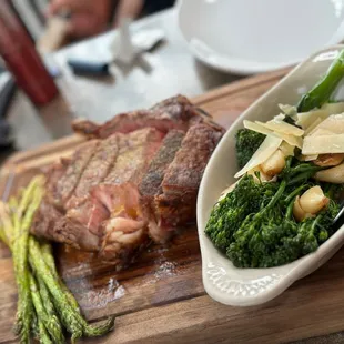 a steak and asparagus on a cutting board