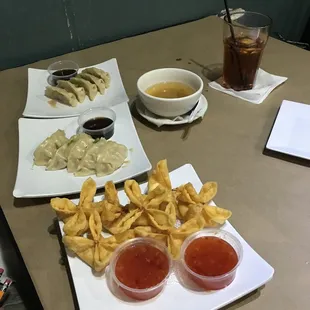 Miso soup, partially eaten, crab Rangoon, Gyoza.
