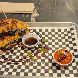 This is a Loaded Steak Melt with BBQ and a "dipper" of tomato basil.  This was amazing, straight from the menu.