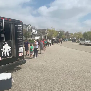 a line of people walking down a street
