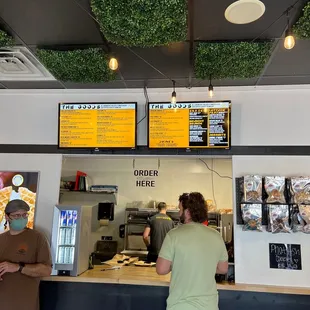 two men standing at a counter