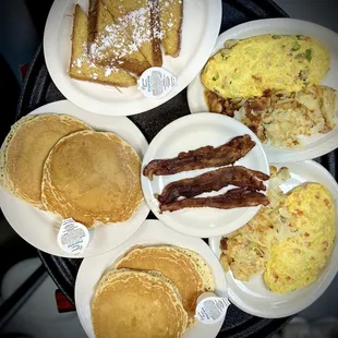 a variety of breakfast foods on plates