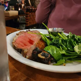 Prime rib with spinach.