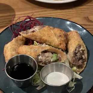 Filet tip egg rolls with horse radish and soy sauce.