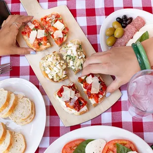 hands grabbing a piece of bread