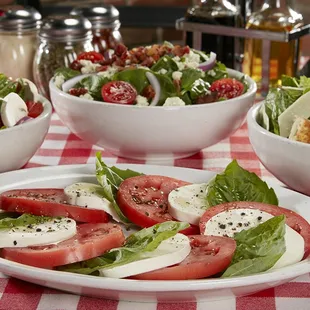 a salad with tomatoes, mozzarella, and mozzarella cheese
