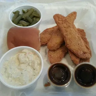 Chicken strips with two sides and a roll.