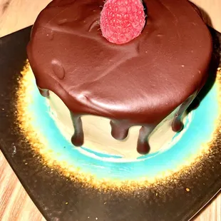 a chocolate cake with a raspberry on top