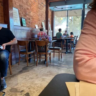 a woman sitting at a table in a coffee shop