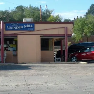 a red car parked in front of a building