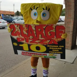 a man dressed as spongebob holding a sign