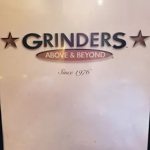 a sign for grinders above and beyond