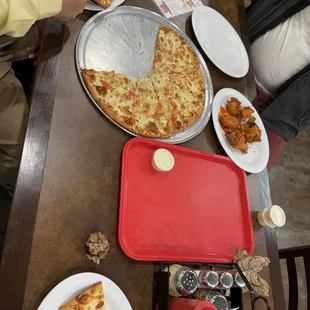 Wings and white garlic pizza