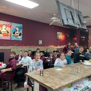 a large group of people sitting at a table
