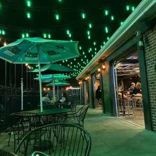 a patio with tables and umbrellas
