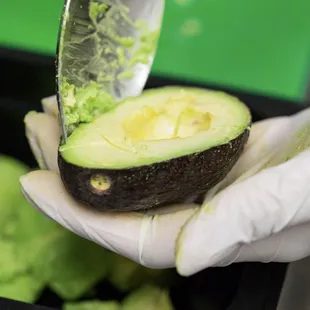 an avocado being sliced