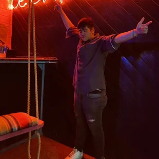 a man standing on a swing