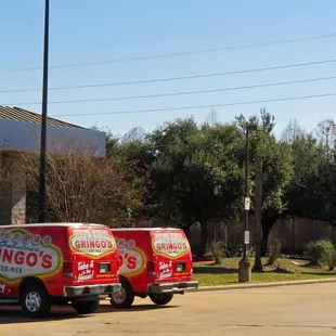 a red truck parked in front of a sign