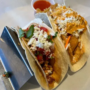 two tacoss on a plate