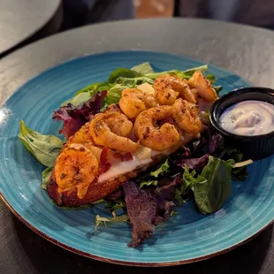 Plantain Split (Shrimp, Bacon, Pineapple, Cheese) with a side of sour cream