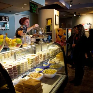 a woman serving food to customers