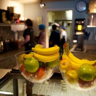 two bowls of fruit on a counter